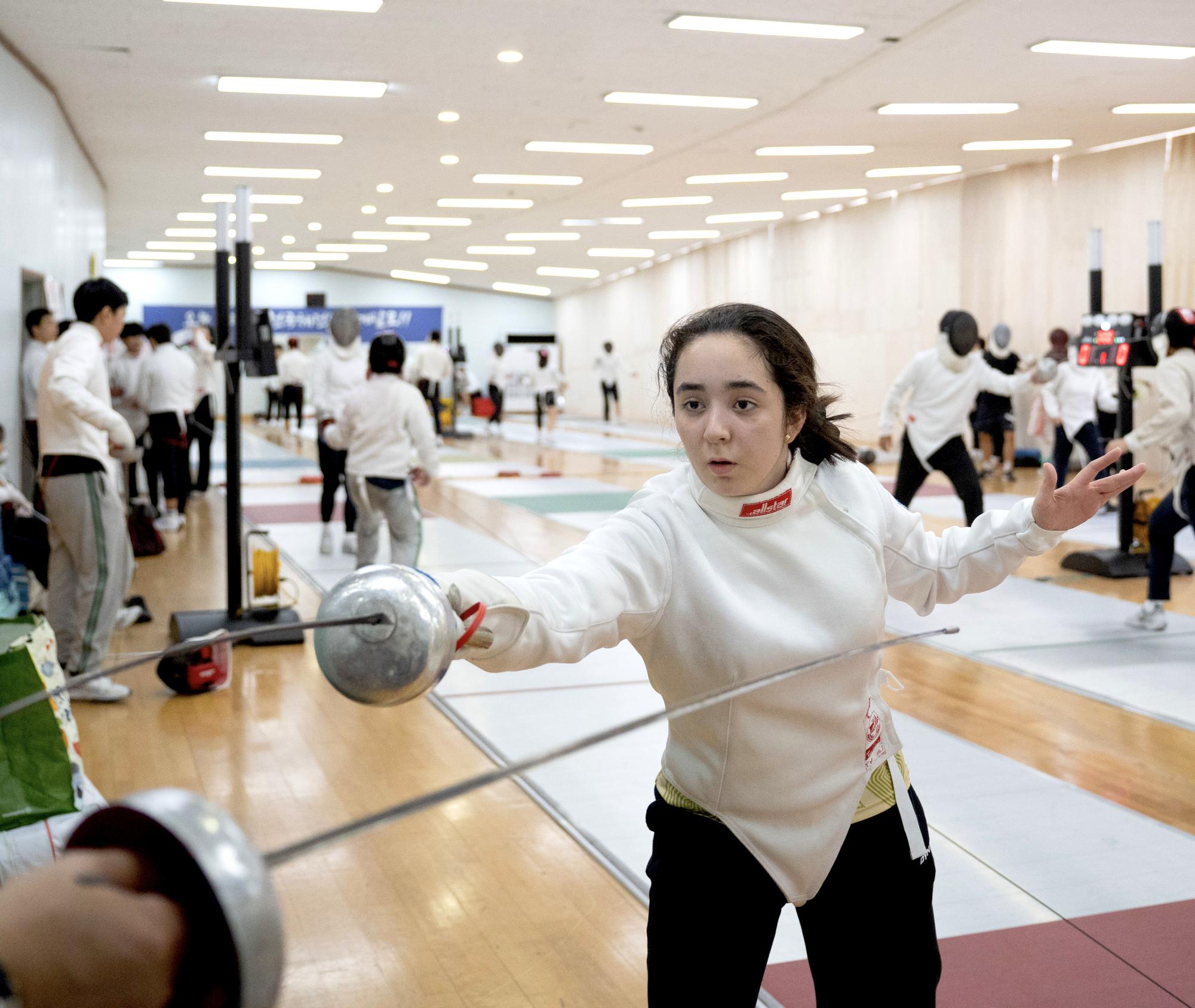 Rivera thrusts her sword, unsure of what her coach means by "keep your territory." Eventually, they sort out the situation and resume practice.
