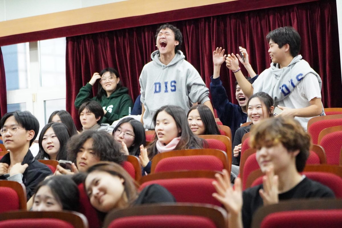 Sophomore YiManuel Cortez roars in triumph after he finishes the trivia contest on the podium. His energy boosts everyone to compete for the prizes. 