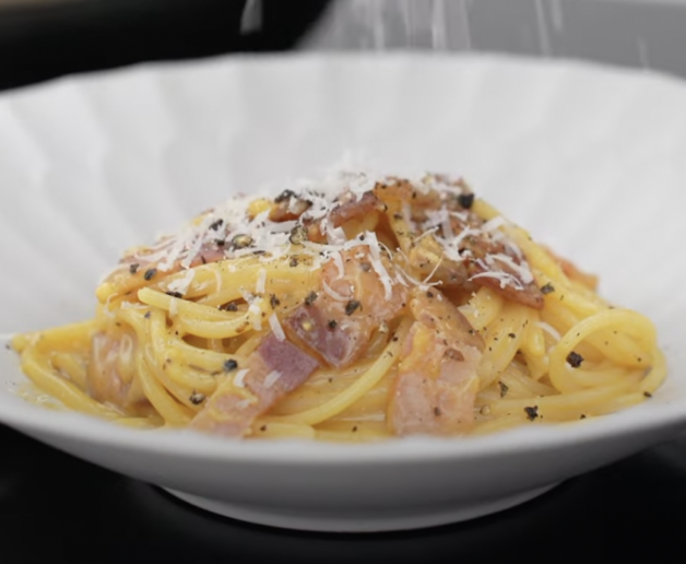 The parmesan cheese snows across the creamy carbonara.