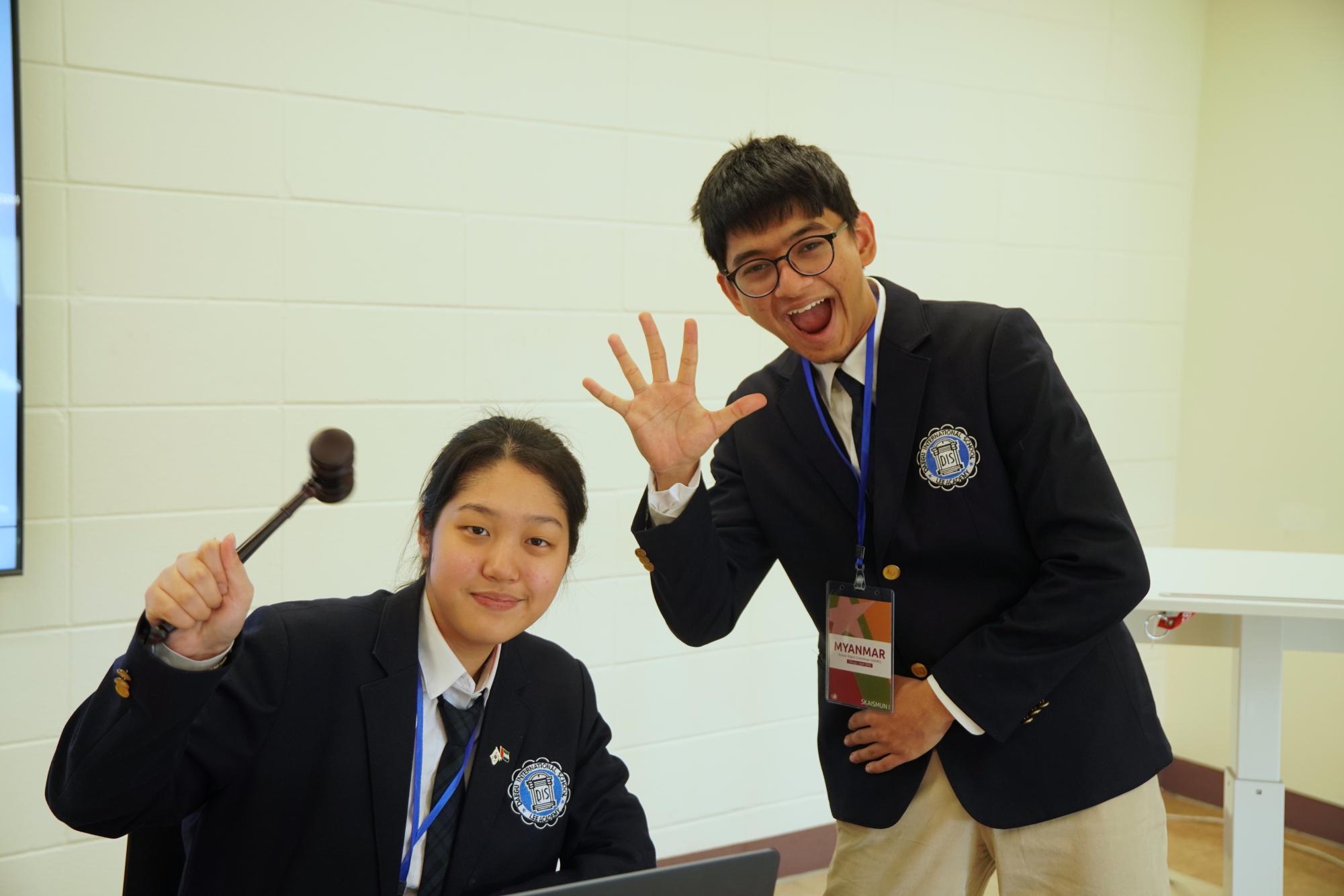 Senior Selina Son holds the gavel with poise and represents the team as a committee chair. She chit-chats with freshman Chirayu Joshi, delegate of Myanmar, during the break. 