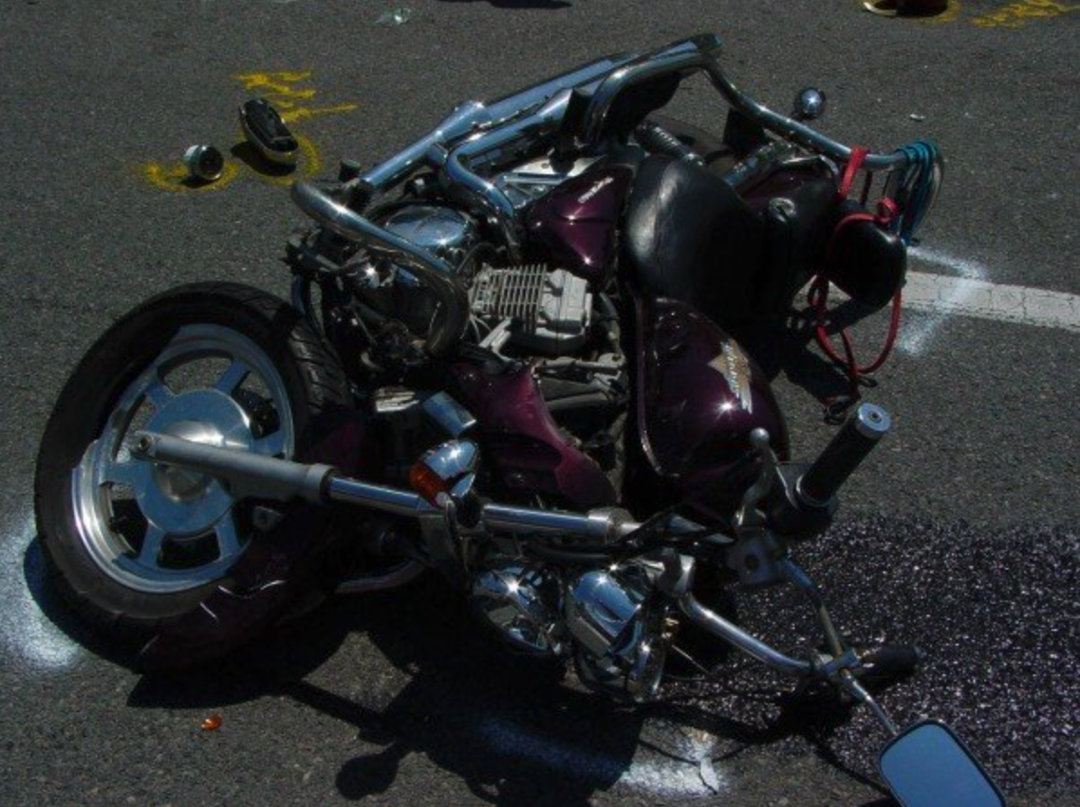 After the crash, the deformed remnants of Mrs. Crewe's motorcycle litter the road. The tragic scene reflects the danger she survived through. Photo courtesy of Mrs. Crewe. 