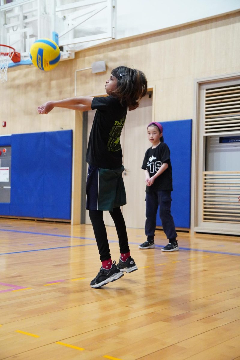 Fourth grader Tanushkaa Banerjee puffs her cheeks out as she focuses to deliver a stable tump. Her precise focus and timing ensures that the ball sails smoothly to her teammate. 