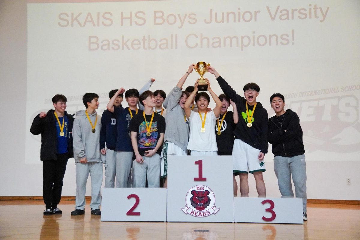 The boys claim the first trophy of the JV division for the Jets at the home of the Bears. Although the competition ended easily, they roar in triumph and celebrate with excitement. They all thank Coach Jang for leading them throughout the season.
