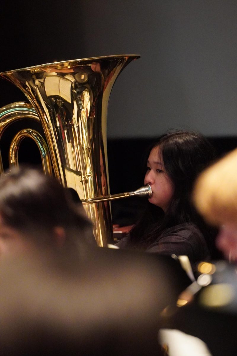 Seventh grader Isabel Bae keeps a firm embouchure for a sonorous tone, effortlessly filling the auditorium with rich notes. She anchors the ensemble with the tuba’s heavy bass. Photo by Maria Park.