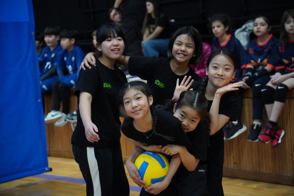 The girls’ A team huddles for a group chant after a hard-fought game. Their teamwork and determination shine through in this celebratory moment. 