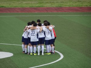 Varsity huddles to go over the game plan. Captain Jayden Ahn shouts "Jets on three" as the rest of the squad chants together. 