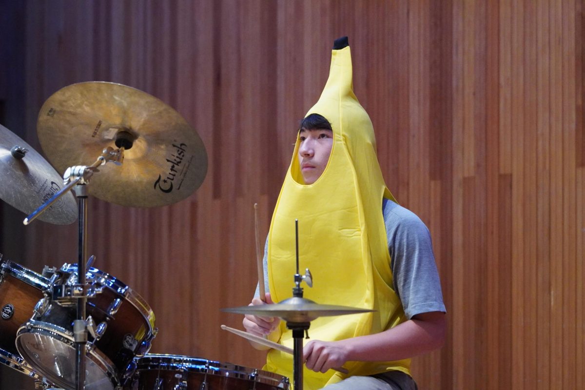 Sophomore Noah Hwang swaps his classic hot dog costume out to go bananas for the final assembly of the year. He pounds on the snare to bring the song to its climax.