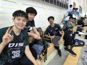 The Jets boys' badminton team celebrates their two-day tournament with their rackets up in the air. They look forward to returning next year and achieving at a higher rank. 
