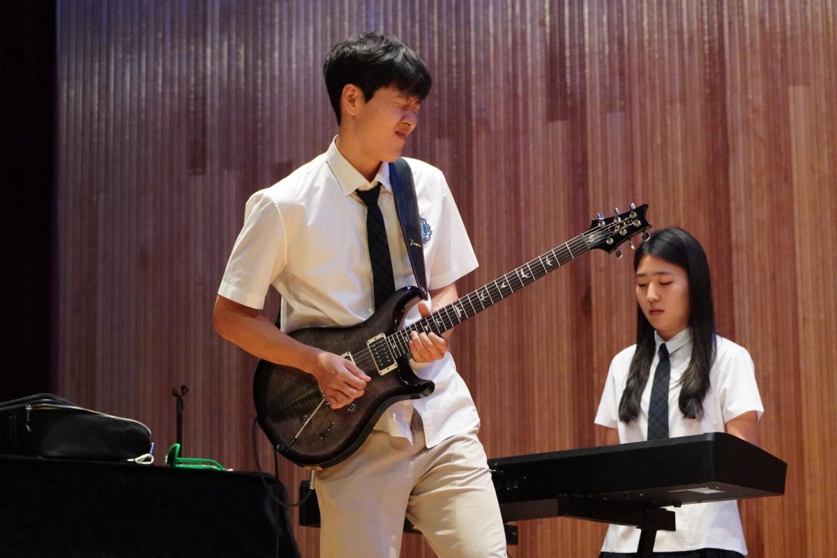 Colin Ji, with precision finger picking, grunts his “guitar face” while losing himself in the song "Don't stop me now" by Queen. He recreates the '70s classic with his fellow GS25 members. 