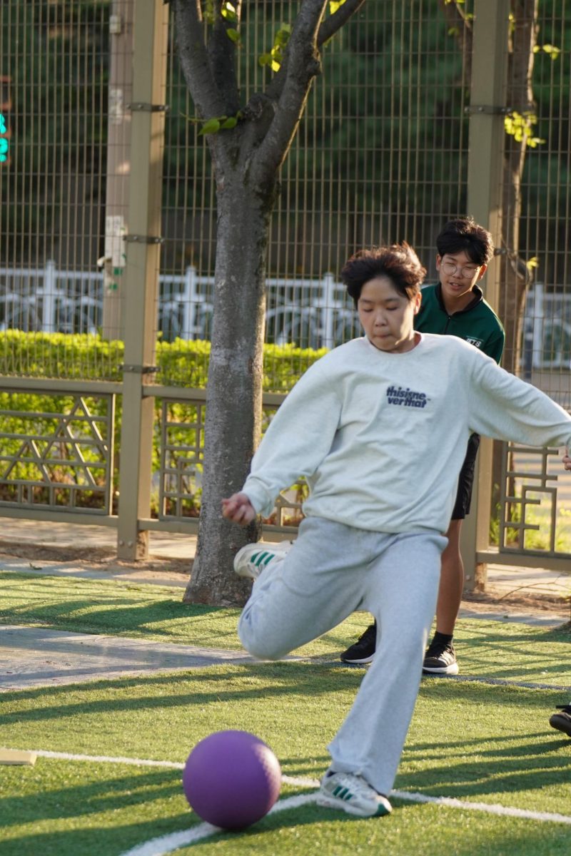 Seventh grader Alex Hyun draws out his soccer kicks during an intense game of kickball. His immense strength sends the ball to the end of the field.