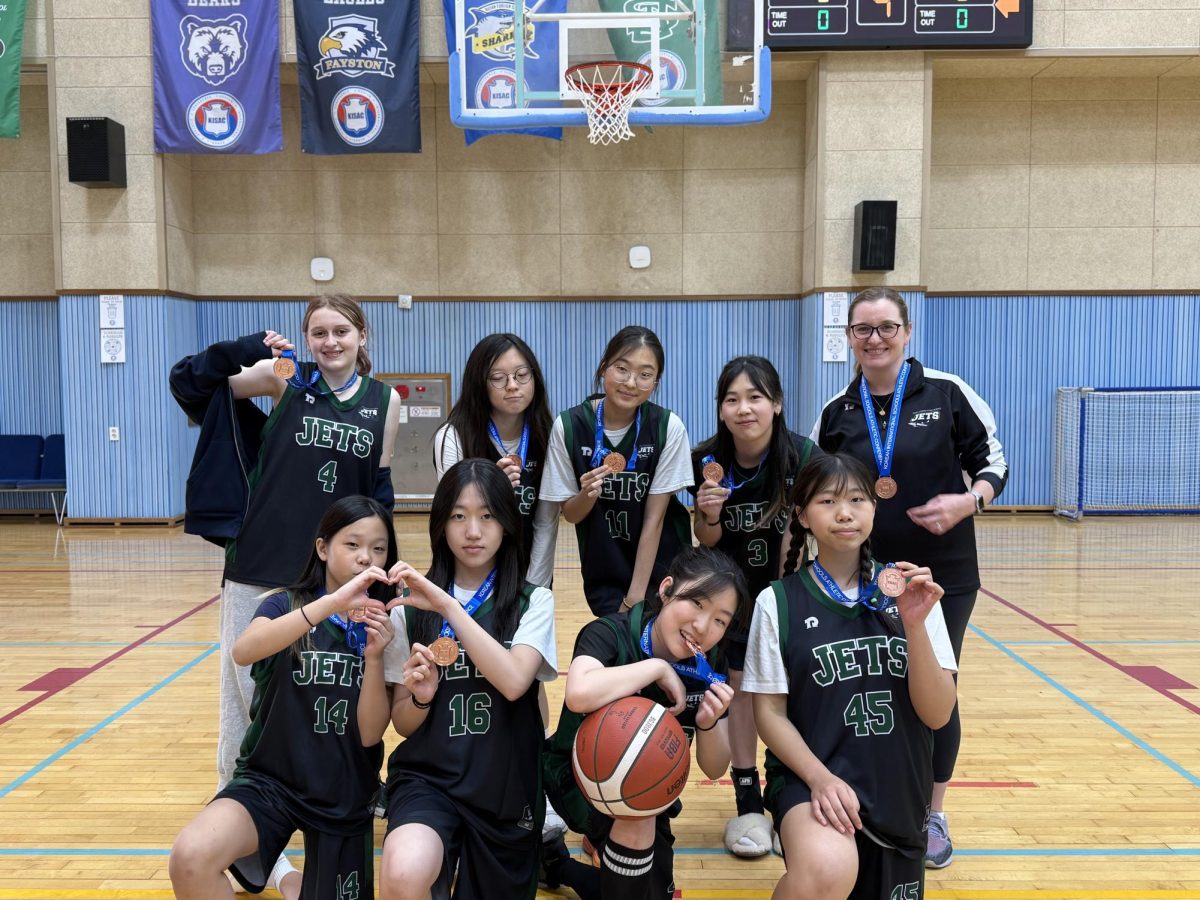 The JV girls proudly gather wearing their bronze medals around their necks. Their close-knit formation captures the hard work and team spirit behind their achievement. 