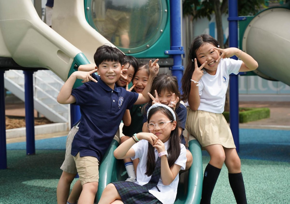 The second grade squad gathers around the mini slides for a group picture on the first day of school. Excited and nervous, they set up their goals for another successful year.