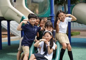 The second grade squad gathers around the mini slides for a group picture on the first day of school. Excited and nervous, they set up their goals for another successful year.