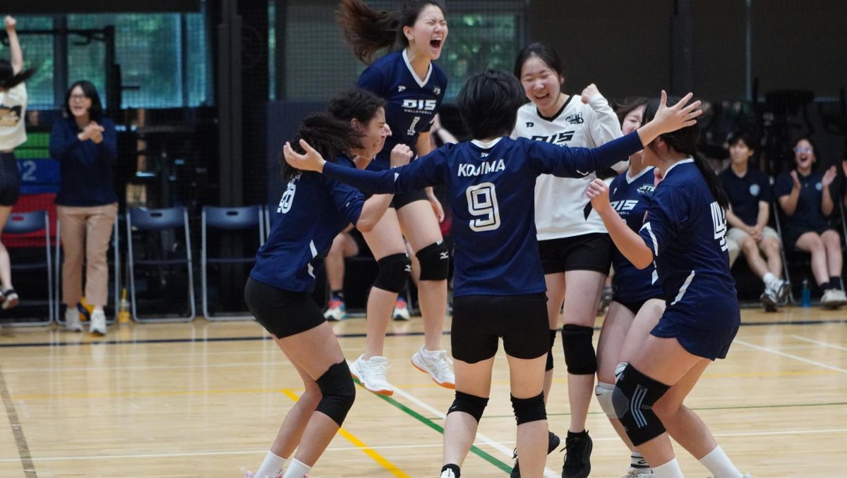 The varsity girls erupt in celebration after a hard-fought rally, their teamwork and resilience shining in every play. United by determination, the squad’s spirit fuels their comeback momentum on the court. 