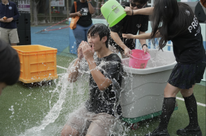 High School Student Council members sophomore Kaylie Jeong and junior Oliver Park splash water on Secretary William Seo in a burst of laughter and cheers. The playful moment served as a joyful finale, wrapping up the day’s festivities with spirited energy.