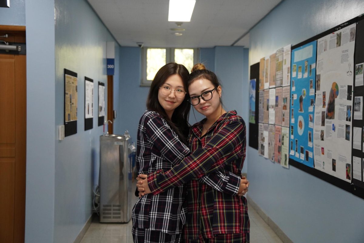 Senior Christine Mason and Chloe Cho cling to each other in matching plaid pajamas. Their laughter fills the halls as they show off their school spirit. 