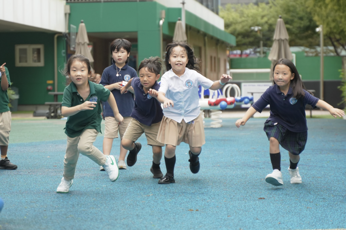 First and second graders enjoy a lively game of Red Light, Green Light. Through unstructured play, they build social and emotional skills that go beyond the classroom.