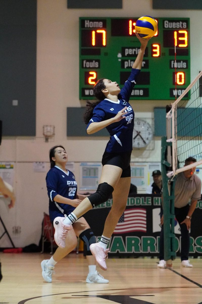 Freshman Luisa Silva (26) jumps as high as Michael Jordan, tipping the ball over the net. Her strategic touch sends the opponents scrambling. Photo Belle