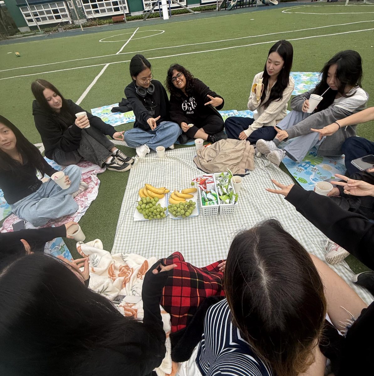The class of 2026 sits in a circle for a game of Truth or Dare. They revel in the moment of camaraderie with the snacks that teachers and parents provided. 