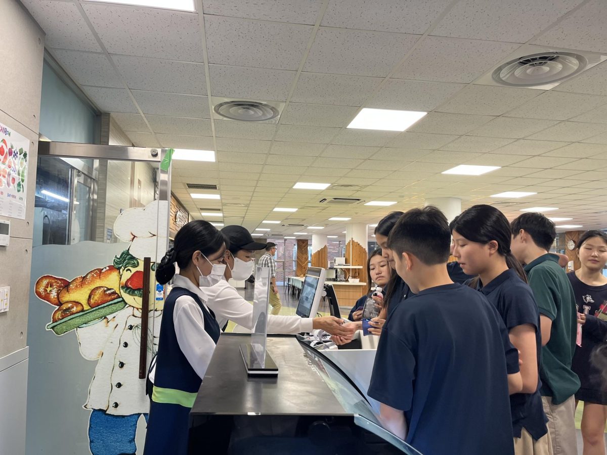 Students line up at the Snack Shop before the University Fair, picking out treats to enjoy before their ASAs. Two managers handle the busy crowd with quick service and friendly demeanors, keeping the line moving smoothly.