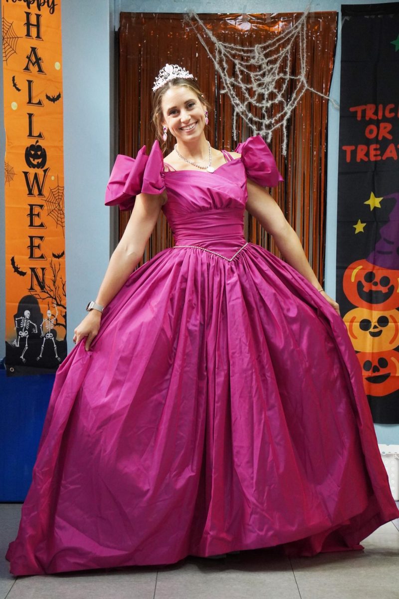 As elegant as ever, second grade teacher Mrs. Kaschub lights up the room with her dazzling smile and magenta dress.