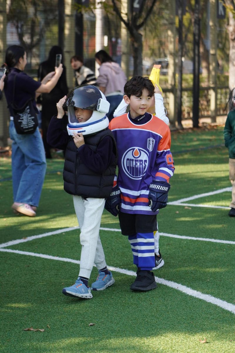 Second graders Harvey Kim and Damian Kim get ready for takeoff, both gleaming in their proud astronaut and hockey attire. The two explorers march forward, ready for new adventures.