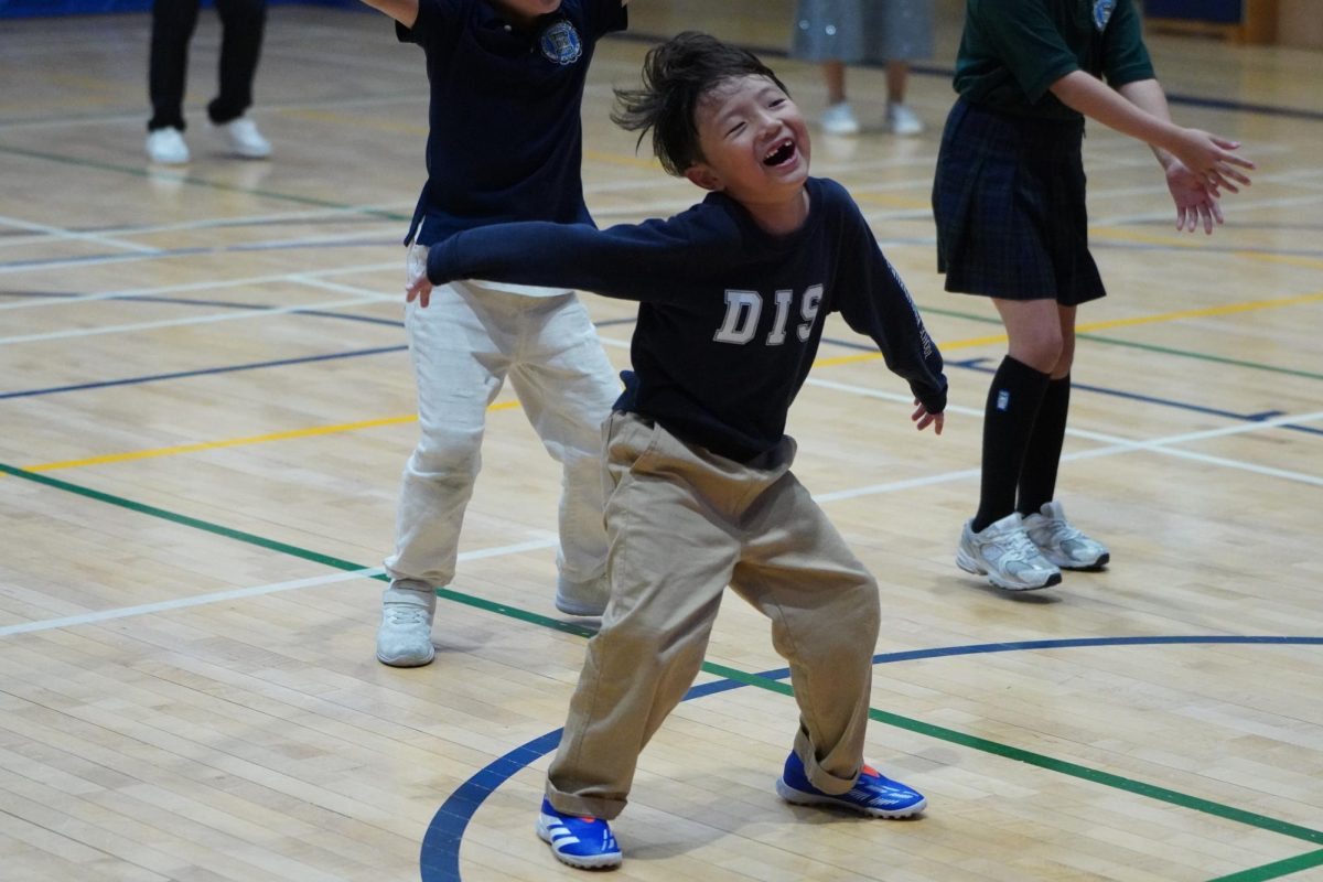 Paul Lee in second grade wiggles his entire body to the rhythm of the music. His groove wows Ms. Medina and his peers. 