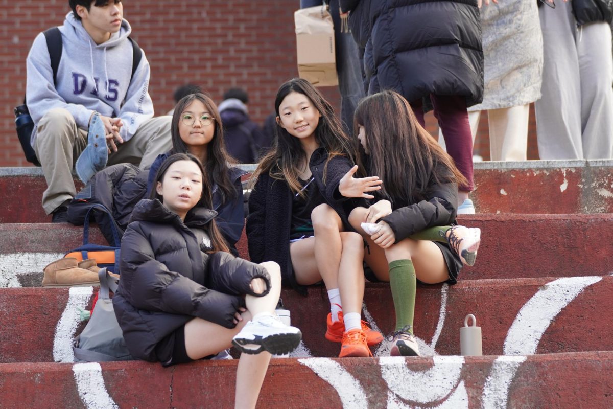 A group of sixth graders gather and encourage one another before the races begin. Even in the biting cold, determination keeps the runners warm..