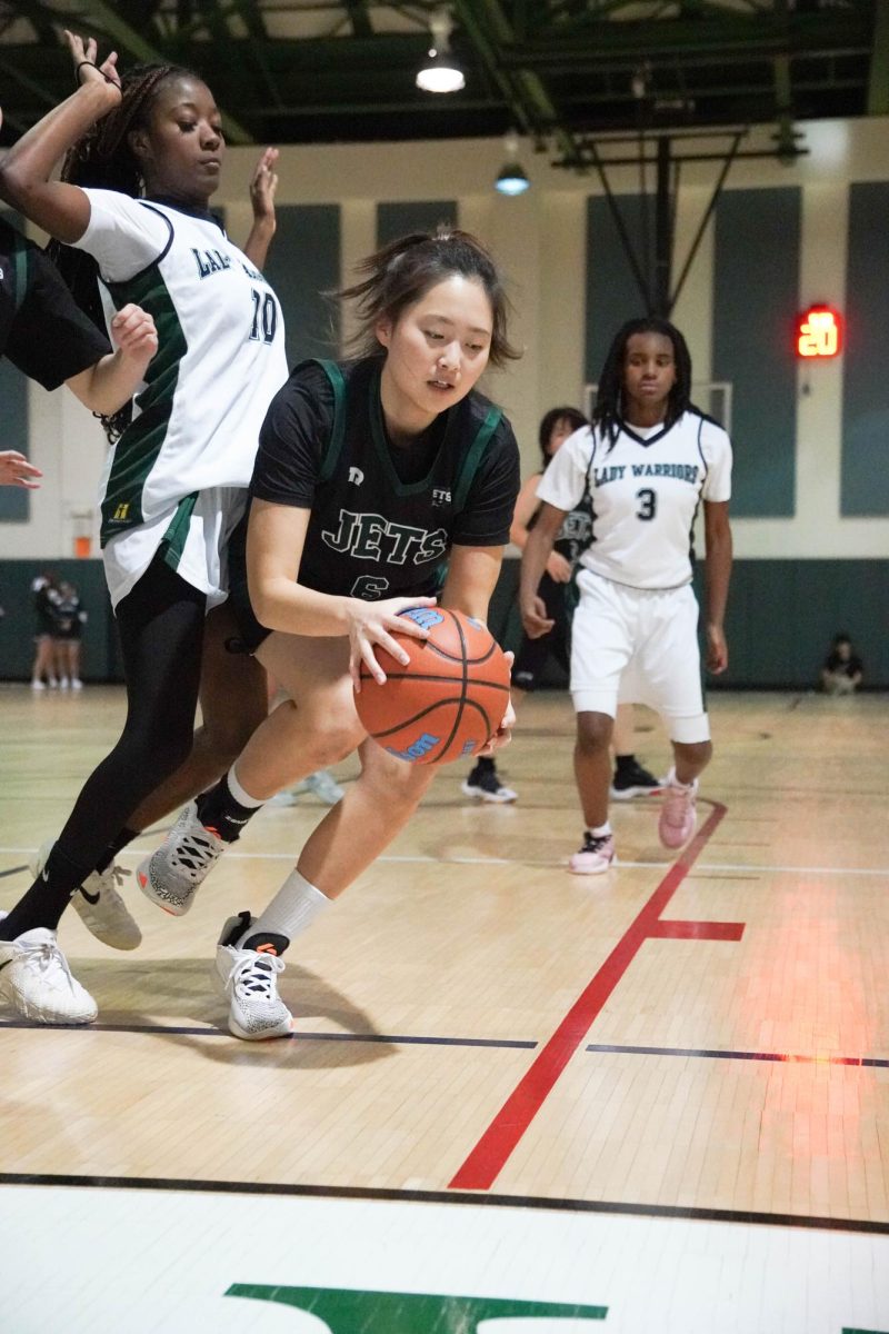 Bonnie Kim (6) slides past two warriors with nimble feet. Despite high pressure, she goes for a basket.
