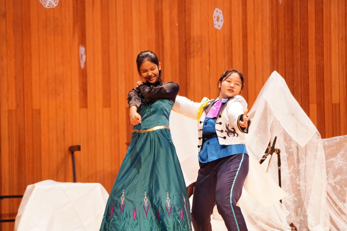 Sixth grader Purnima Cha and freshman Katniss Kim twirl to "Love is an open door." Their chemistry ramps up the audience's anticipation for the classic finale. 