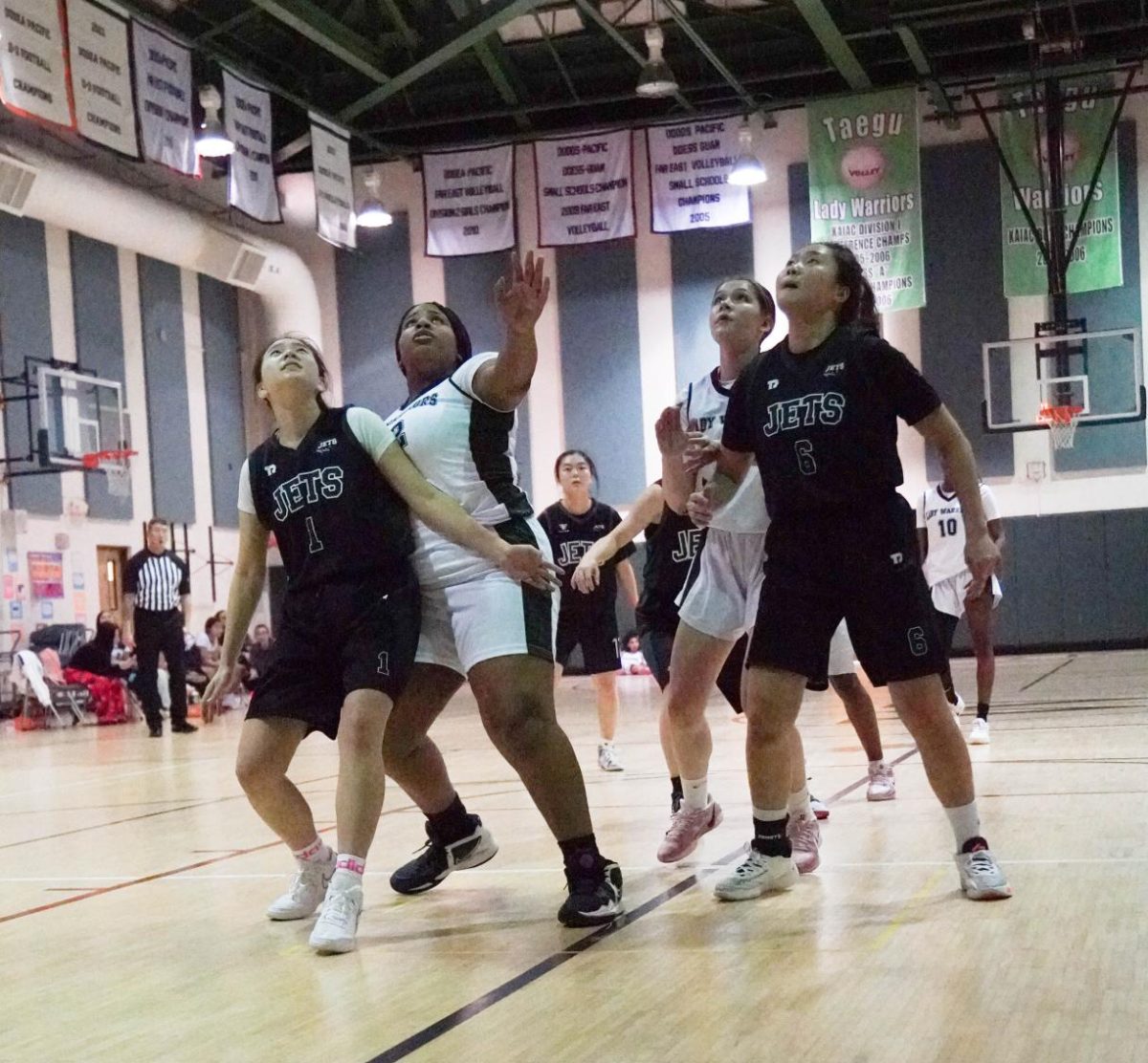 Leewen Wang (1) and Bonnie Kim (6) fight for rebounding position in the paint as the ball bounces off the rim. They box out the warriors to secure possession.