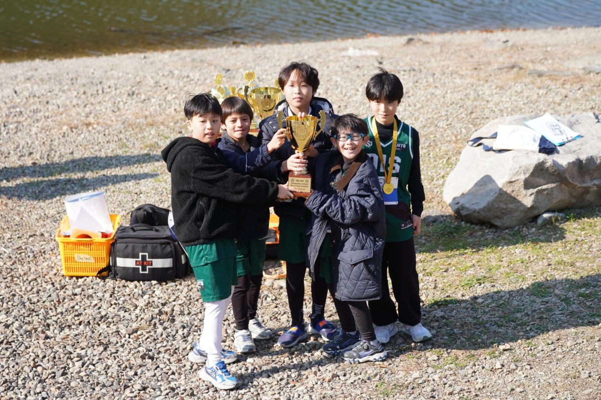 Elementary runners boast their trophy after a series of strong performances at the cross country dash. Their hard-earned victory reflects teamwork, determination and growing confidence on the course.