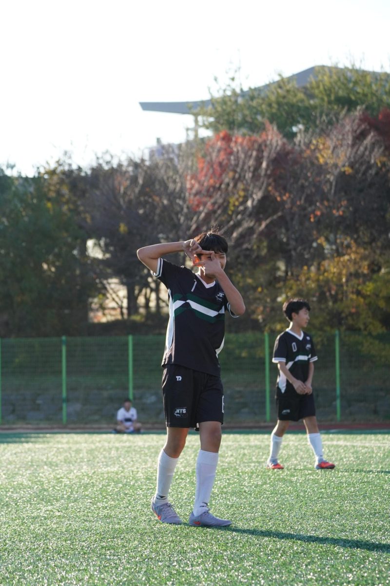 Steven Jang (1) imitates Sonny’s signature celebration, ecstatic about his goal. He revels in the moment as his teammates watch the score intently.