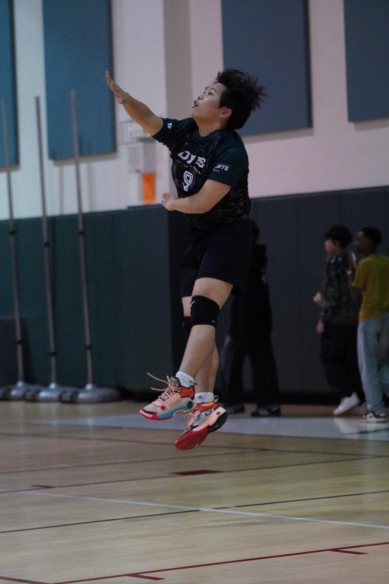 Bryan Lee (9) sends a powerful jump float serve toward the Warriors’ defense. Lee steps up as varsity’s starting setter once again, and he awaits to develop more next year as a senior.