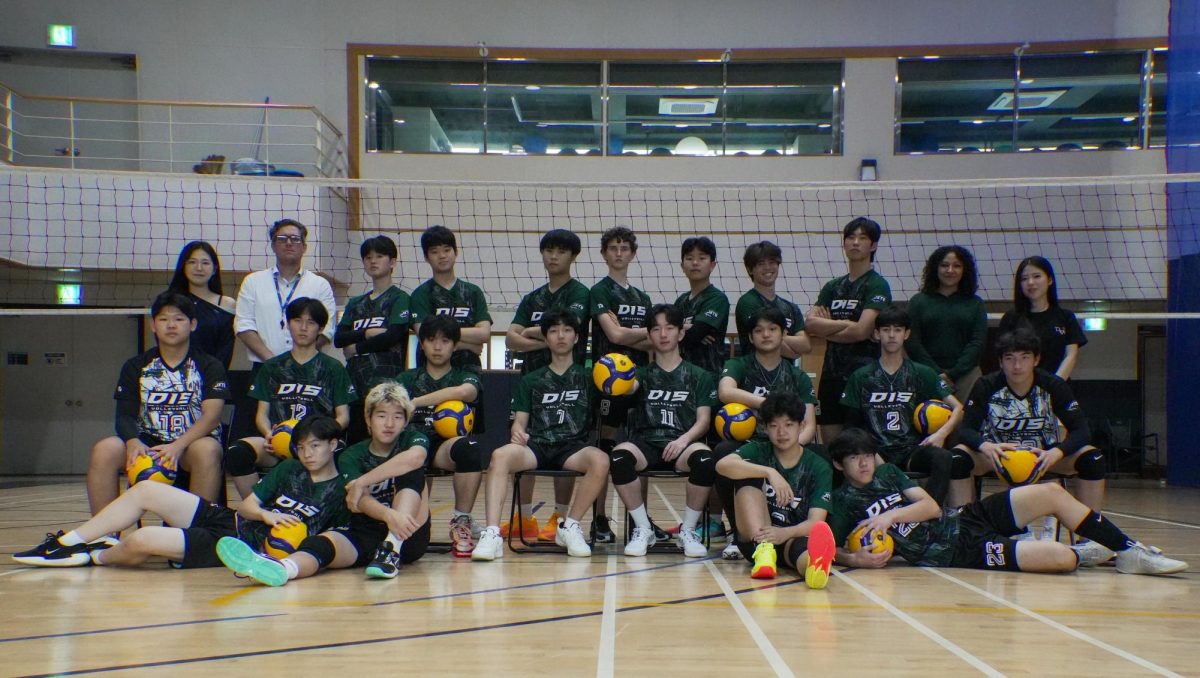 The high school boys’ volleyball team gathers alongside Coach Willette, Coach Marchan, and senior managers Chloe Cho and Jenny Lee. Their efforts and determination wrapped the season with two silvers and two golds finishes – marking the most successful season in DIS athletics.

