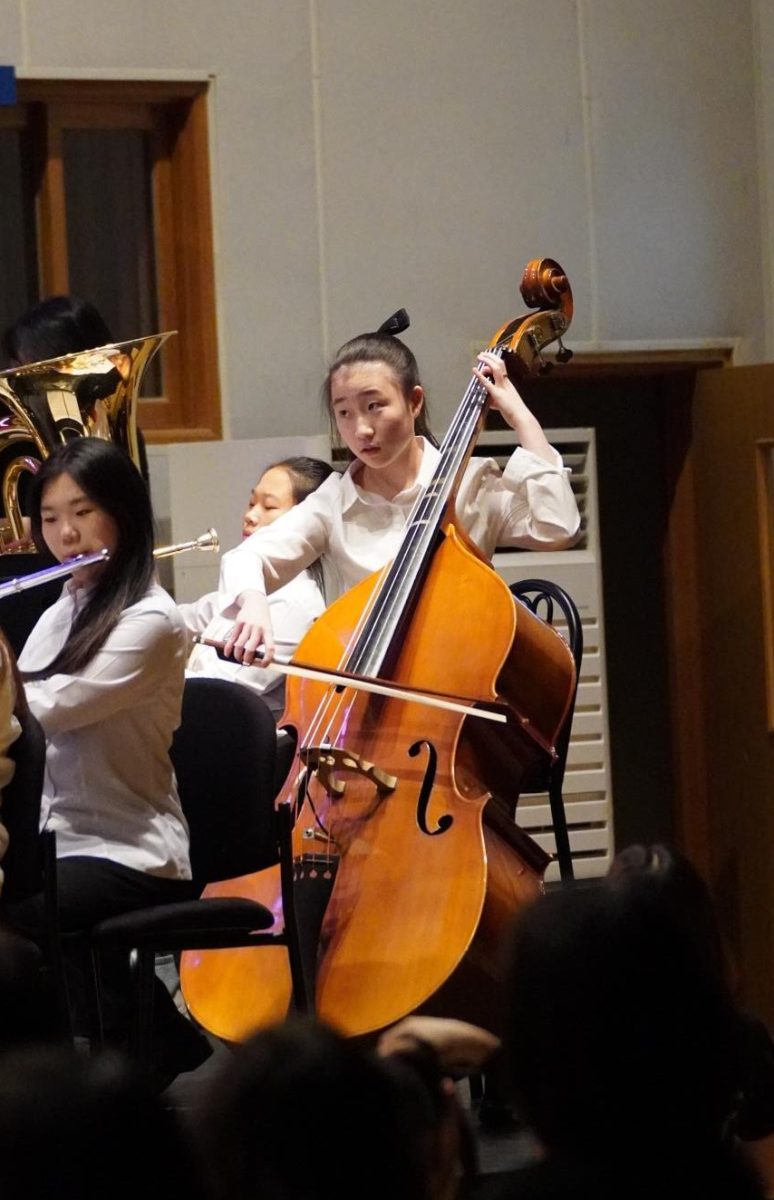 Arin Kwon in eighth grade carefully bows each phrase of note on her double bass. With a variety of instruments, the audience is mesmerized by the diverse dynamics of musical notes.