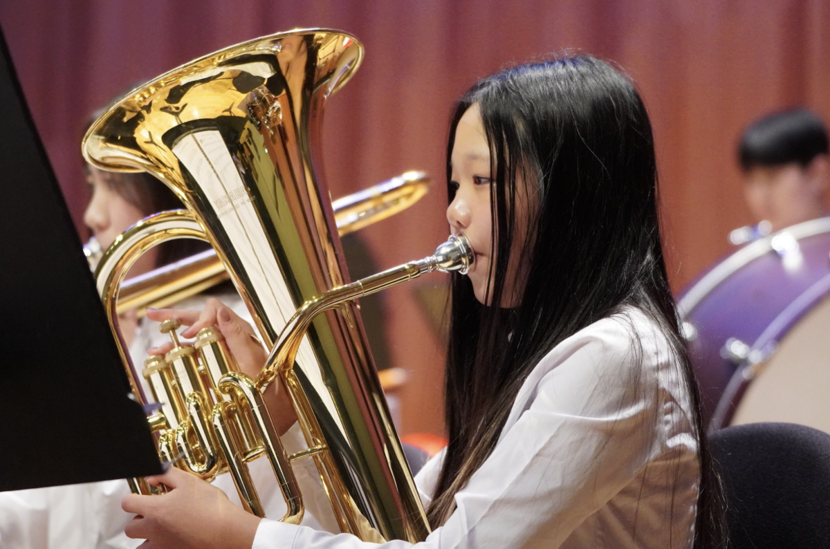 Dana Lee in seventh grade produces a mellow tone with her euphonium to bring calmness in the musical piece. The low-pitched sound from the instrument contributes greatly to the depth and bassline of their performance. 
