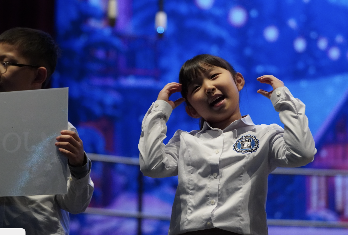 Arin son in second grade moves across the stage with joy and enthusiasm, fully engaged in the performance. Her lively presence and natural delight add warmth and energy to the moment. 