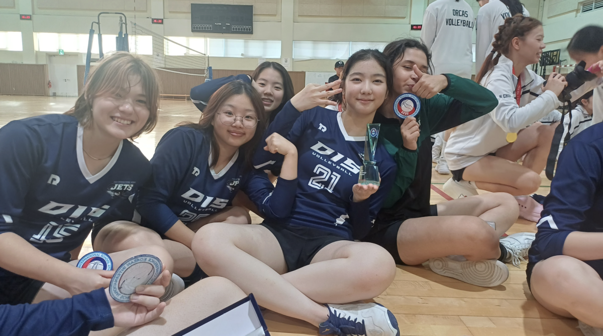 The varsity girls gather on the court after two days of hard work, earning a KISAC bronze medal through grit and perseverance. The moment reflects the effort and resilience that carried the team through the tournament.