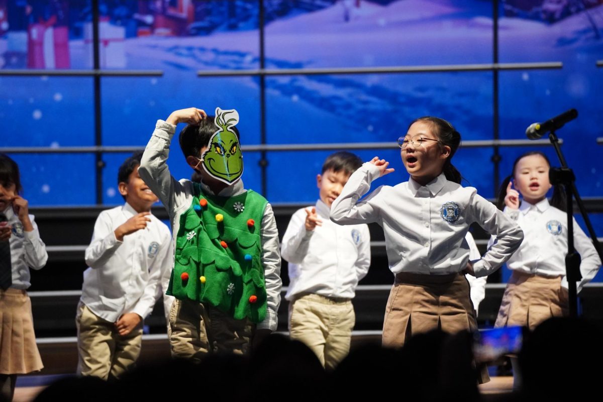 Second grader Dami Son makes her stance in front of the stage. With the creative choreography the grade level made, she immerses herself in the performance.