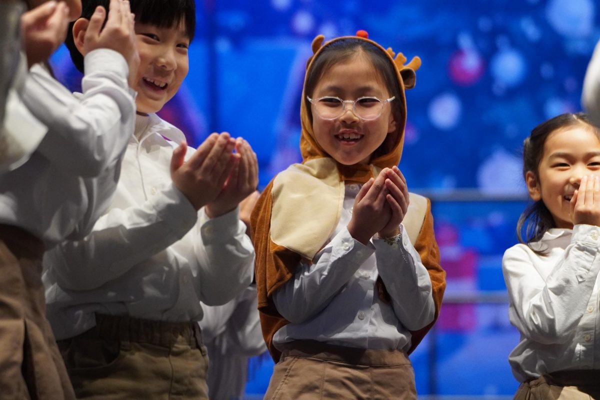 Kiana Jeong in second grade confidently performs her role with reindeer costume. Her bright energy highlights the excitement and confidence gained through movements and music.