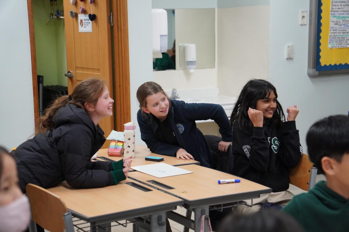 Fifth graders lean in with sharp focus during a heated round of Jeopardy at Leadership Game Night. Their spirited cheers and quick answers capture just how much the event energized the room.