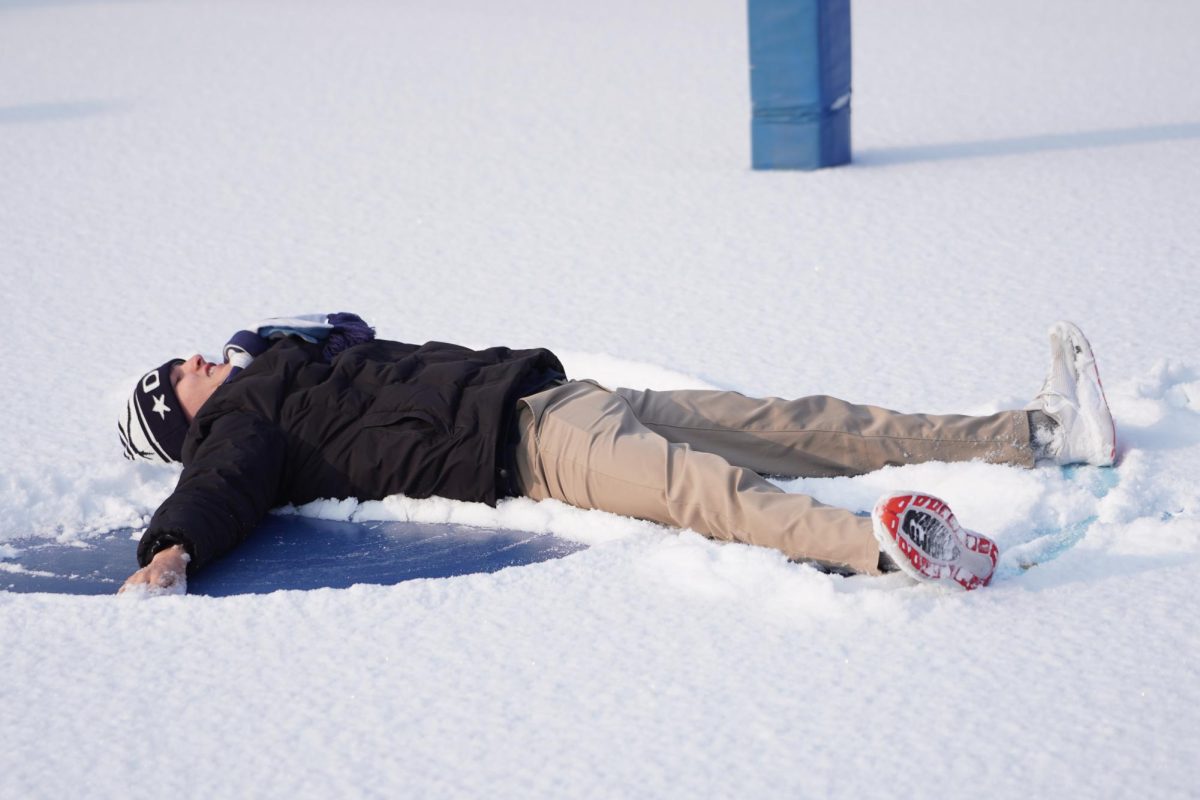 Junior Maddox Jolly lies down on the soft fallen snow, swinging his arms and legs to make snow angels. A wide grin spread across his face as he feels the crisp cold beneath him. 