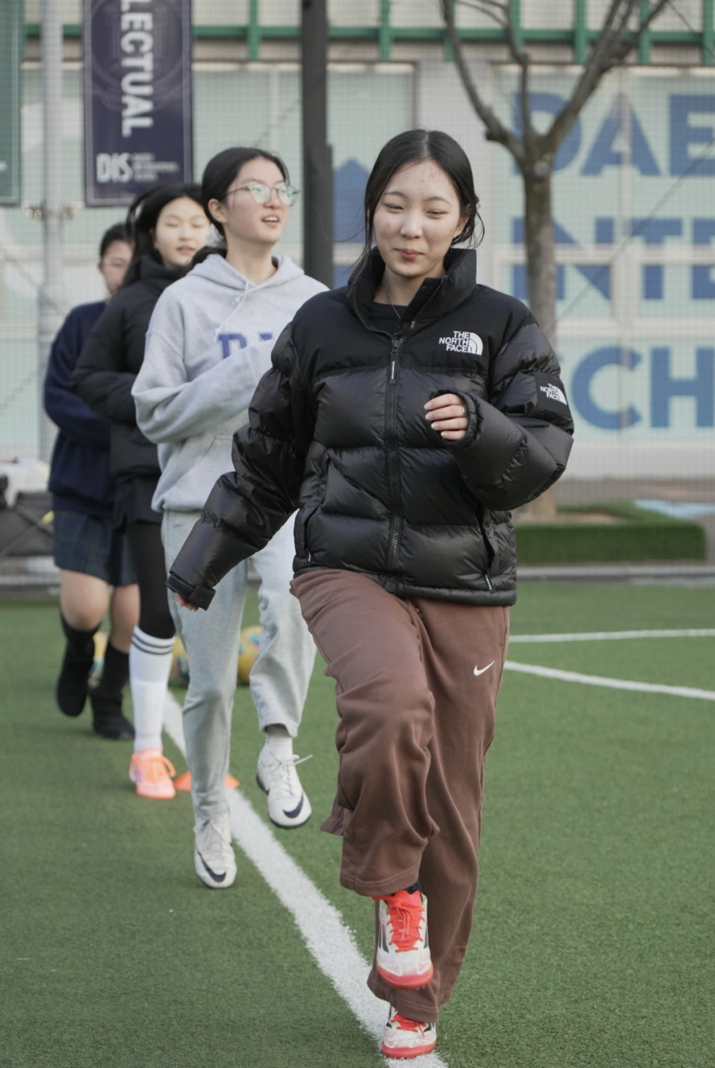 Sophomore center midfielder Kaylie Jeong and her teammates warm up at open field practice, taking advantage of extra time to stay in shape and sharpen fundamentals. These low pressure sessions give them time to focus on personal goals which makes the extra work feel more motivating than mandatory.