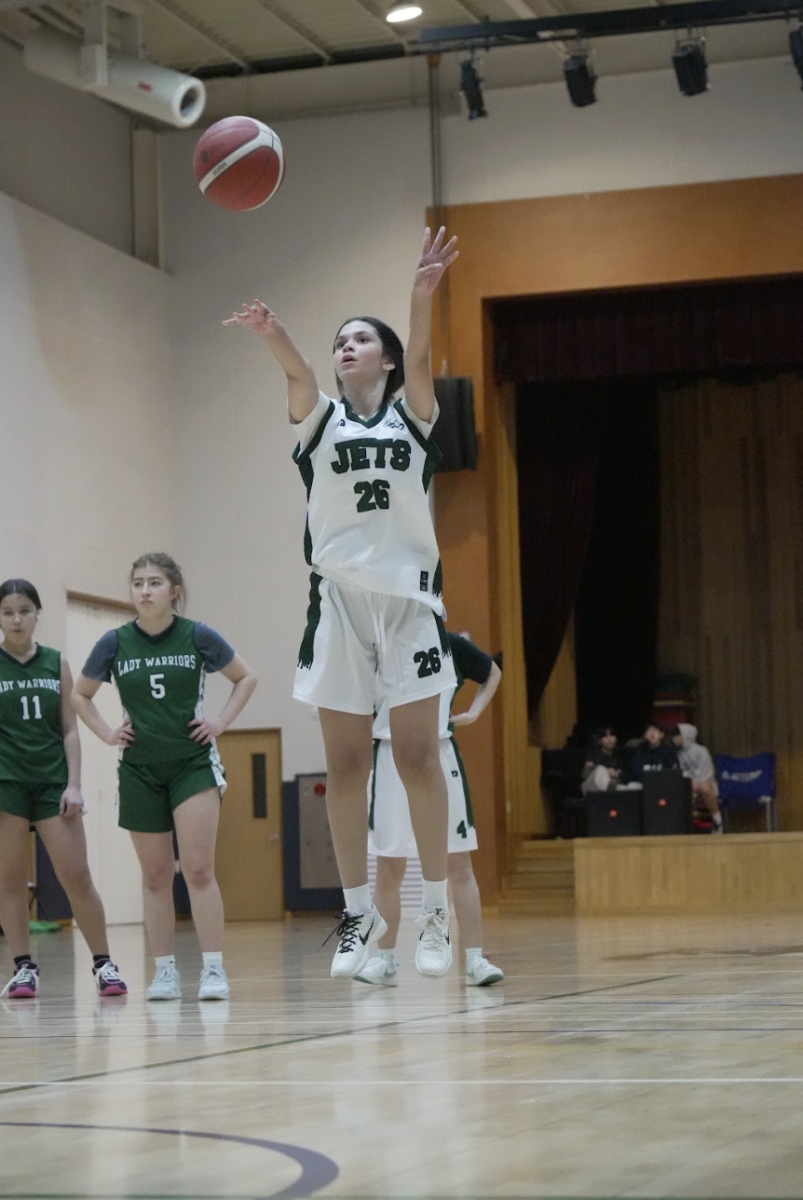 Center Luisa Silva (26) rolls around the ball in her hands through her routine. She zeros in on the rim and pops the ball up.