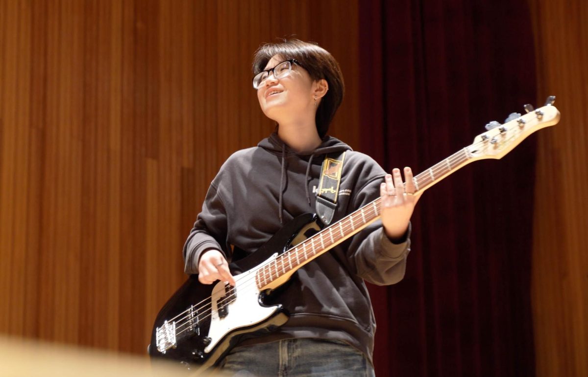 Senior Minori Kojima glances toward her bandmates, anticipating the moment they enter together. She waits to align her harmony with the rest of the band. 