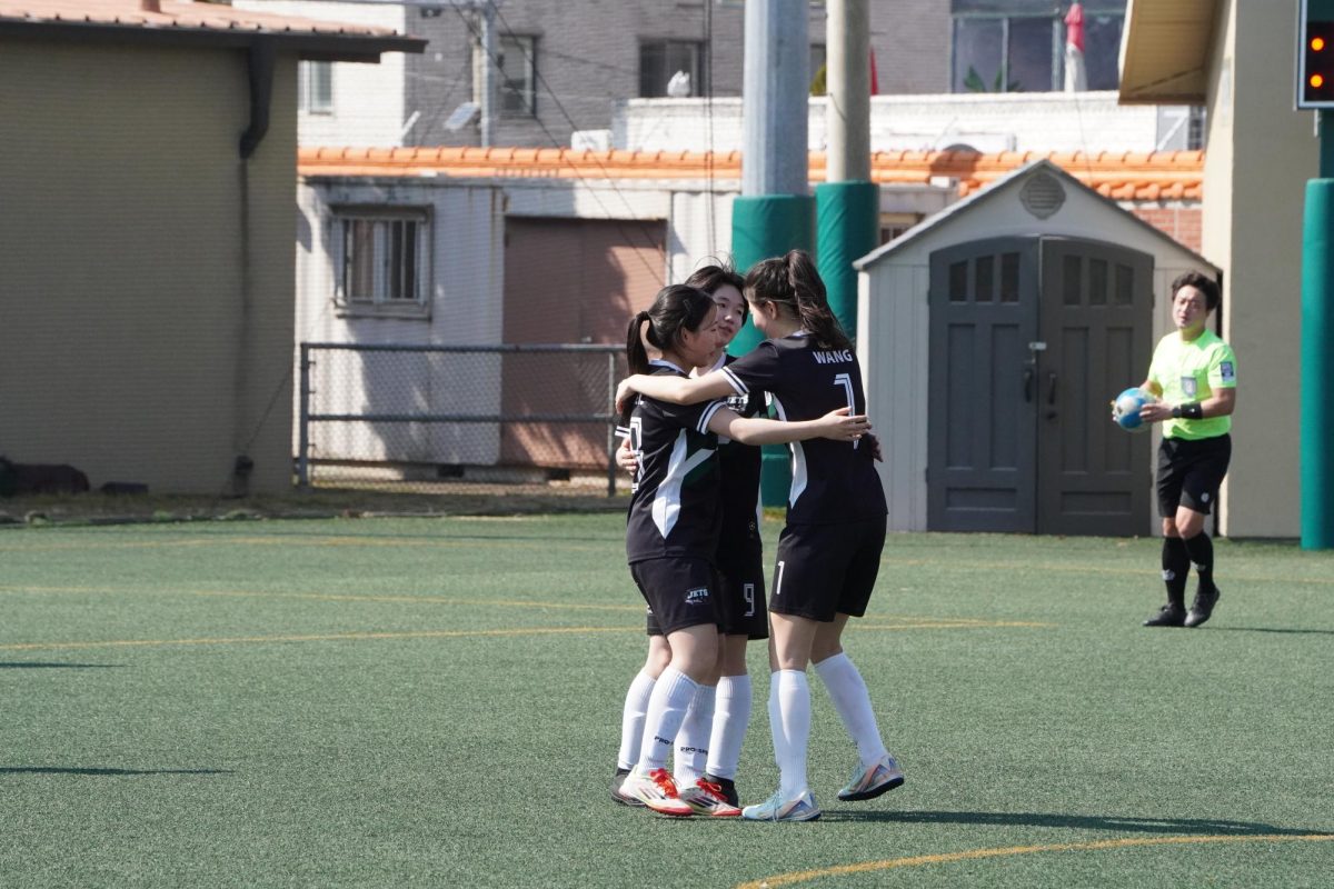 Minori Kojima (9), Kaylie Jeong (28) and Leewen Wang (1) huddles together after scoring a magnificent goal. Despite being in different grades, their communication and bond shone throughout the match. 