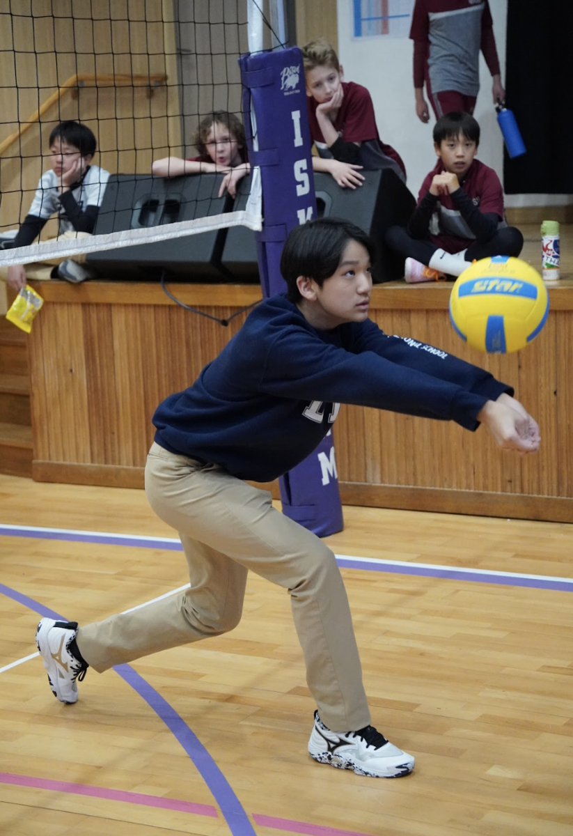 With perfect form, seventh grader Steven Jang receives the spike and redirects the ball back into play. As a student coach, he sets an example for the younger players. 