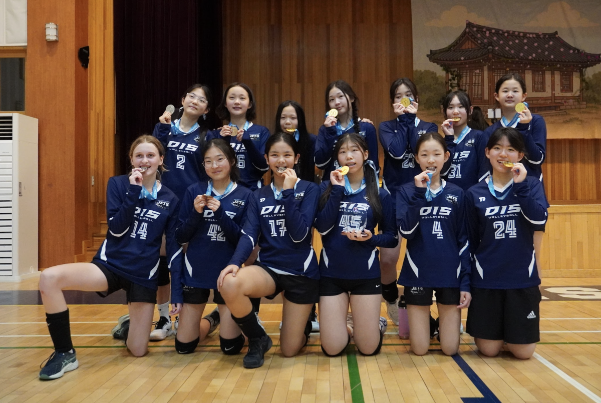 The JV1 and JV2 teams celebrate as they hold up their gold and silver medals. After months of hard work, the girls sweep the top two spots on the podium. 