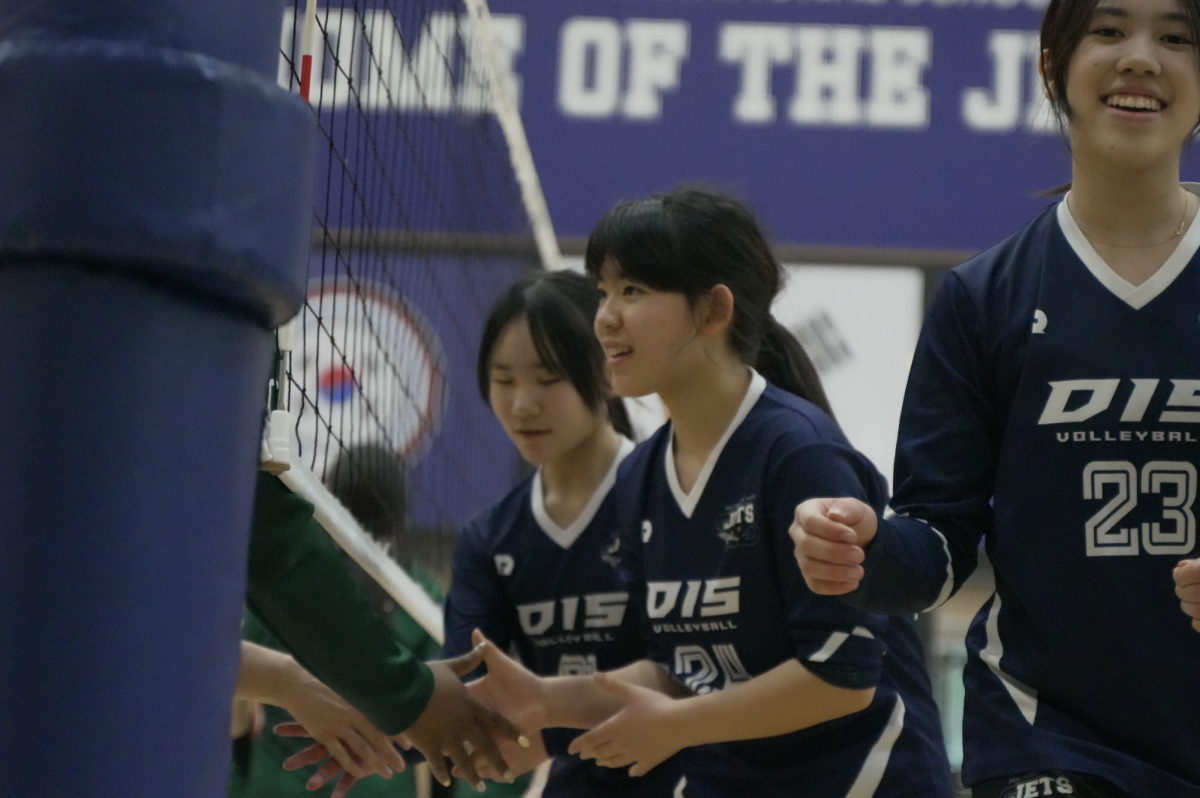 Outside hitter Yujin Park (24) shakes hands with the SJA players, demonstrating true sportsmanship. Her postgame manners reflect the weight the team puts on sportsmanship.  
